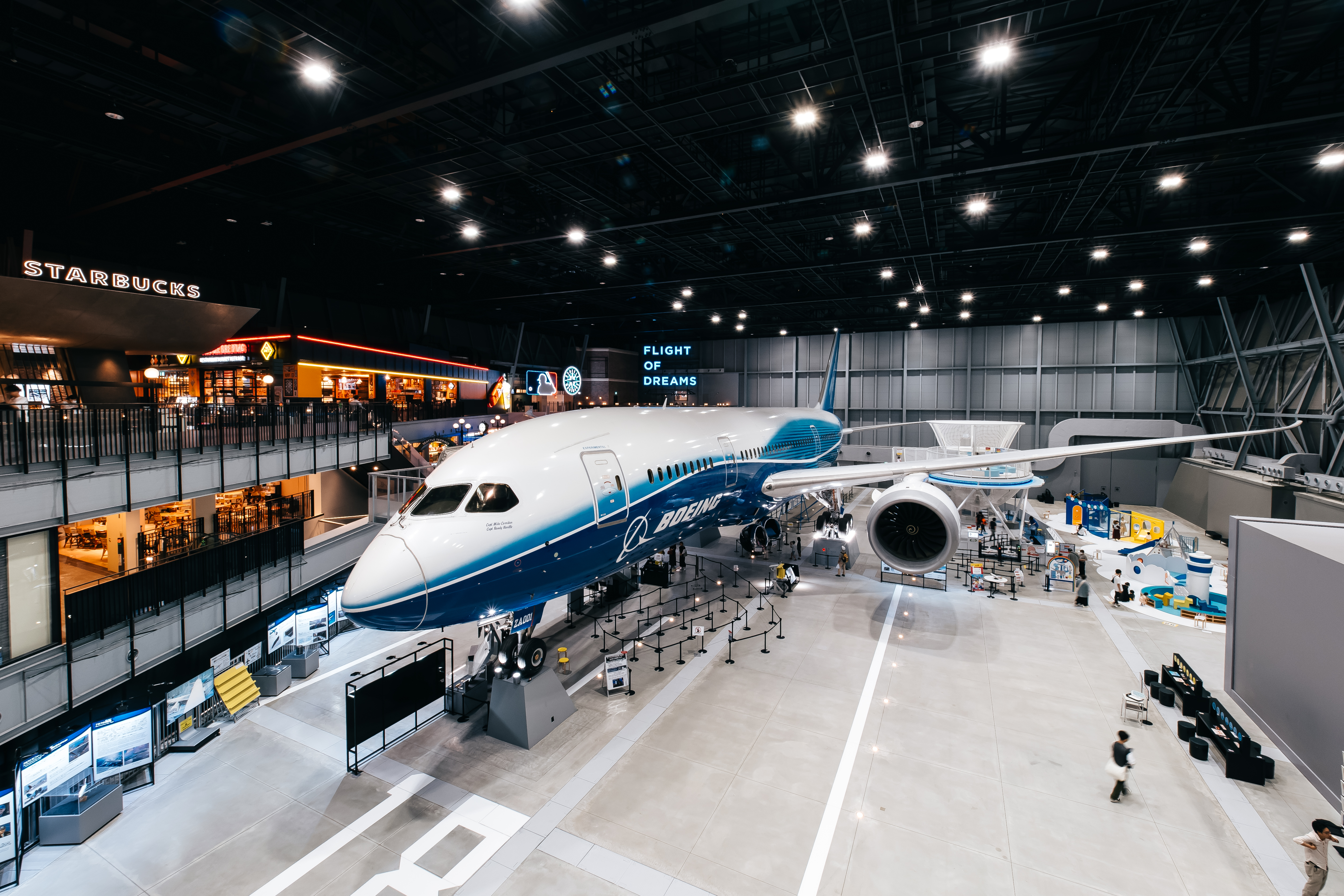 Blue-and-white Boeing 787 Dreamliner on display inside the Flight of Dreams aviation museum.